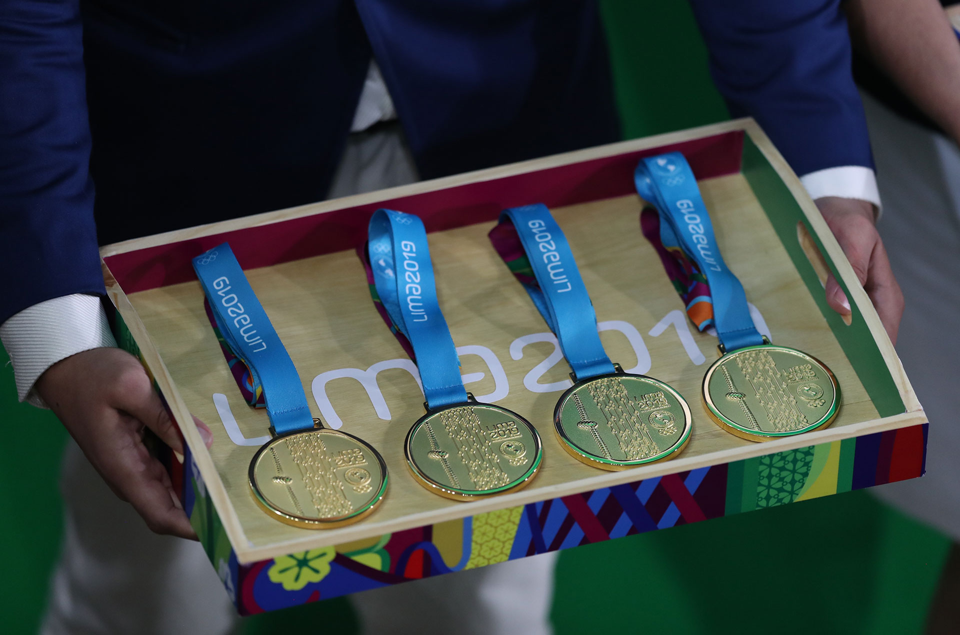 XVIII Pan American Games - Lima 2019 XVIII Pan American Games - Lima 2019 - Athletics - 4x100m Relay Final - Athletics Stadium, Lima, Peru - August 9, 2019. An official carries medals for a 4x100m relay ceremony. REUTERS/Ivan Alvarado