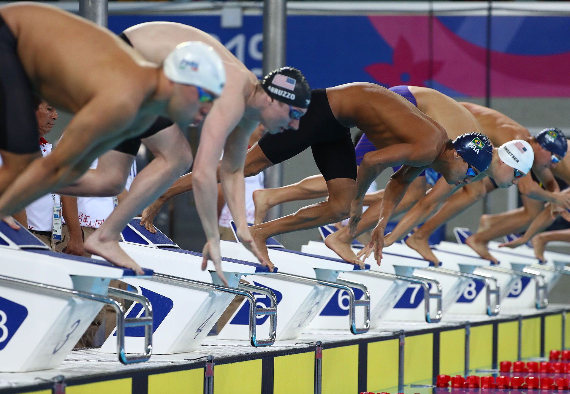 XVIII Pan American Games - Lima 2019 Swimming XVIII Pan American Games - Lima 2019 - Men's 200m Individual Medley - Aquatic Center, Lima, Peru - August 10, 2019. William Licon of the U.S., between José Angel Martinez Gomez, and Brazil's Caio Rodrigues Pumputis at the start of the race. REUTERS/Pilar Olivares