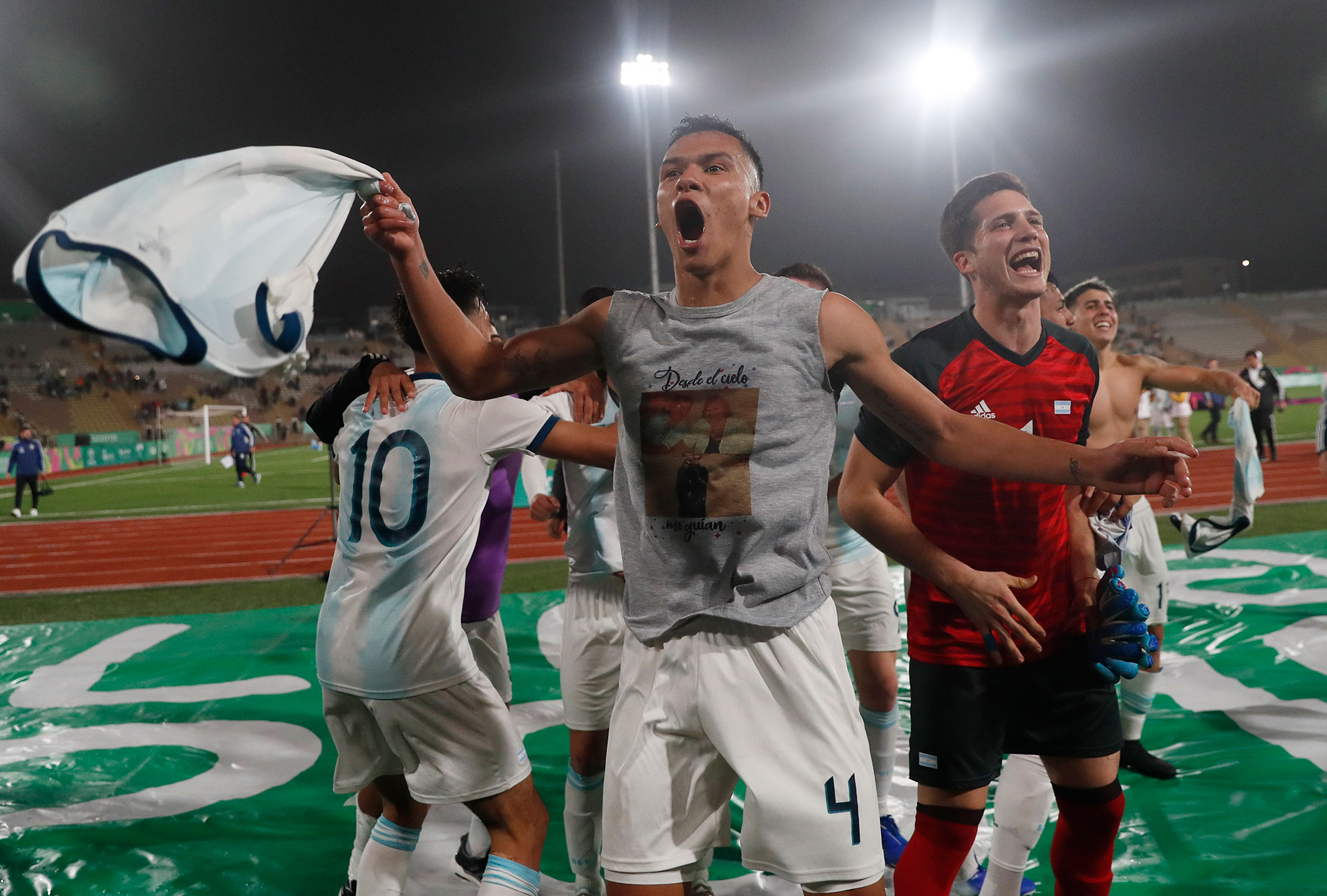 XVIII Pan American Games - Lima 2019 Soccer Football - XVIII Pan American Games - Men's Finals - Argentina v Honduras - Lima 2019 - San Marcos Stadium, Lima, Peru - August 10, 2019 - Argentina's Marcelo Herrera and goalkeeper Facundo Cambeses celebrate after winning the gold medal. REUTERS/Susana Vera